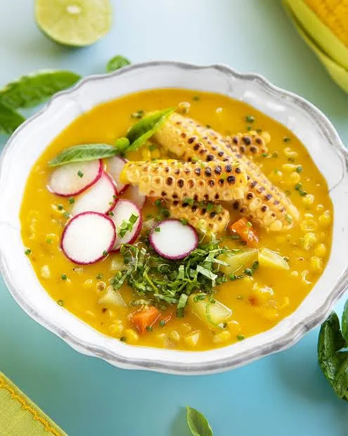 Bowl of creamy corn chowder with corn kernels, potato and spring onion garnish