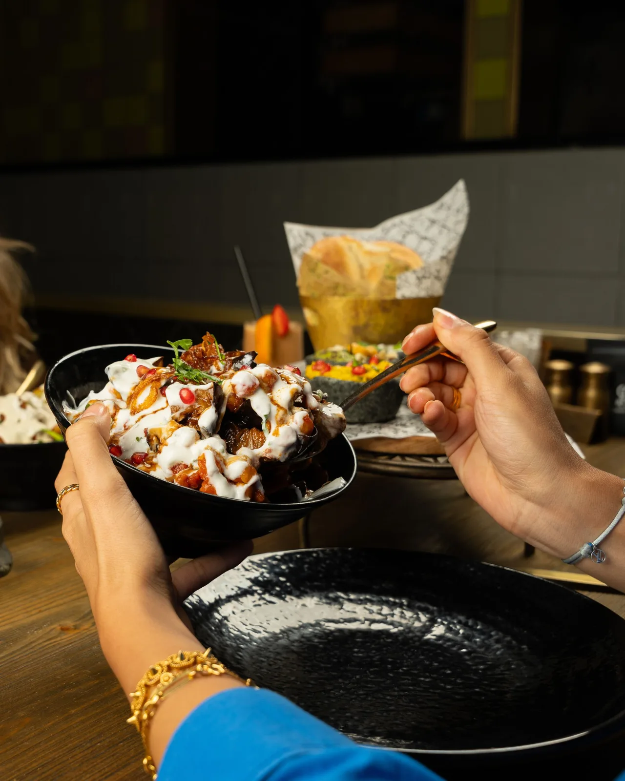 Bowl of Pakistani fruit chaat with apple, guava, grapes, orange, banana and pomegranate topped with mint and chaat masala