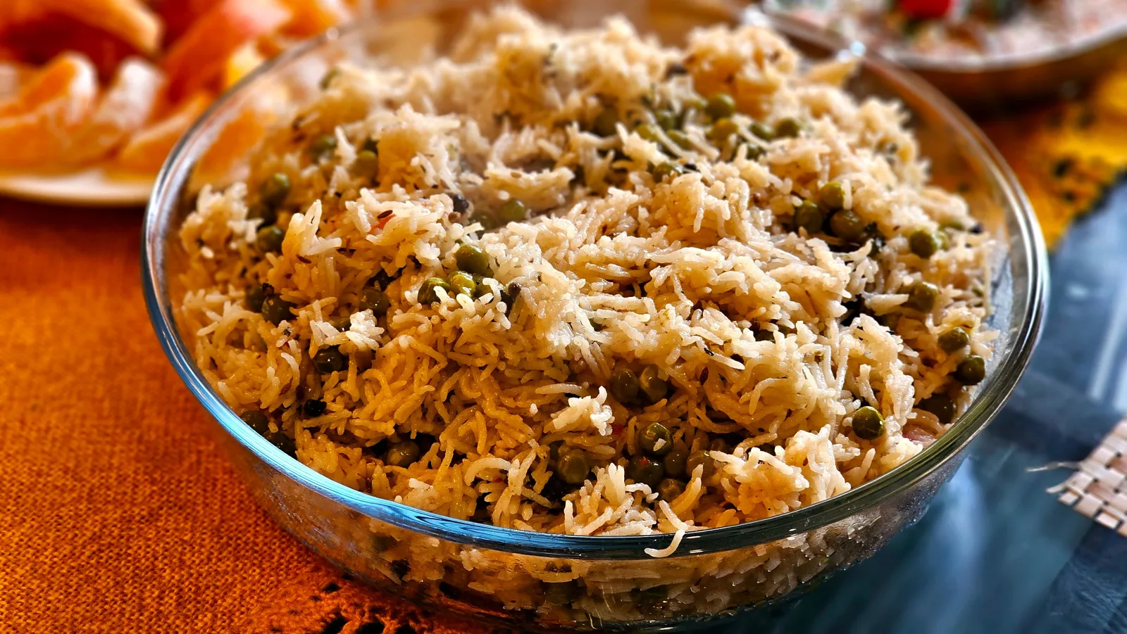Fluffy basmati rice with green peas and fried onions in a serving pot