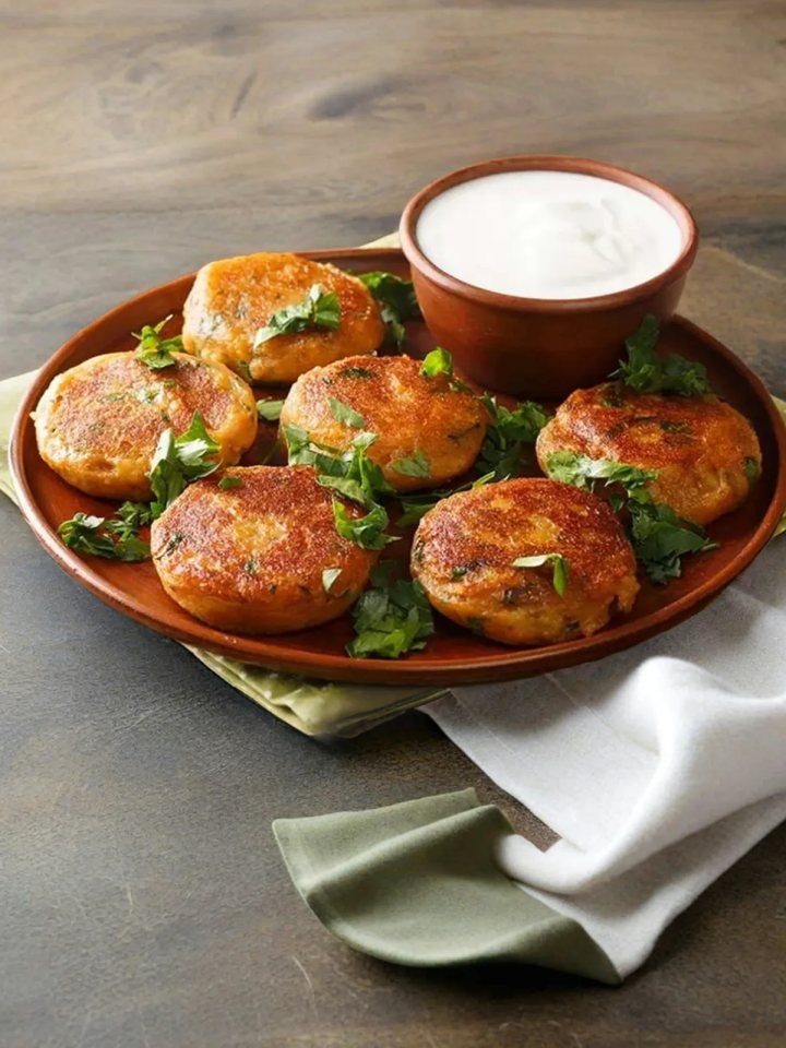 Golden shallow-fried aloo tikki potato patties served with mint and tamarind chutneys