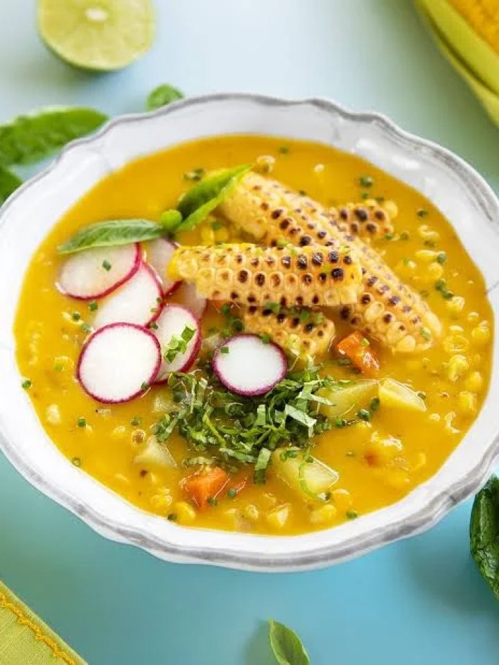 Bowl of creamy corn chowder with corn kernels, potato and spring onion garnish