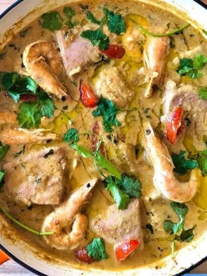 Goan fish curry with fish steaks in a red coconut gravy, garnished with coriander and green chillies